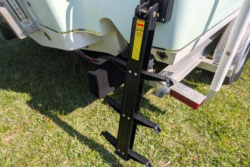 Slide: The Image of 2021 Sea Hunt BX 22 BR boat trailer with attached ladder on grass. - 16