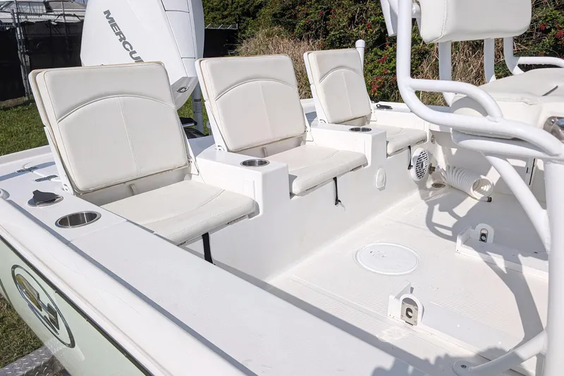 Slide: The Image of 2021 Sea Hunt BX 22 BR boat interior with white seating and cup holders. - 7