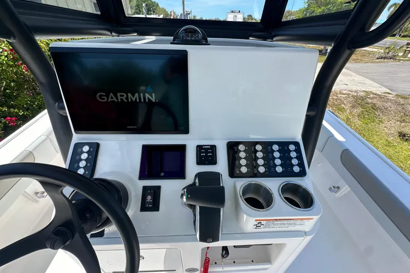 Slide: The Image of 2026 Caymas 26 HB boat dashboard with Garmin navigation system and control panel. - 9