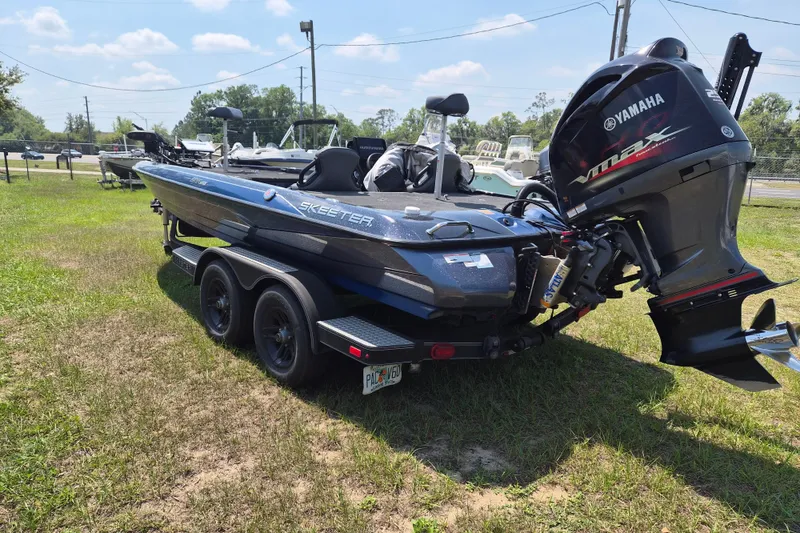 Slide: The Image of 2021 Skeeter ZXR20 boat with Yamaha VMAX engine on grassy area. - 10
