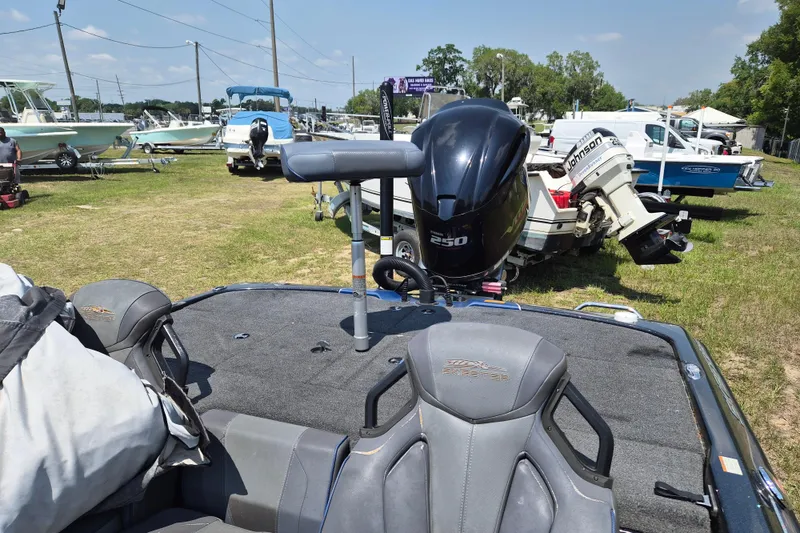 Slide: The Image of 2021 Skeeter ZXR20 boat with powerful 250 engine, parked outdoors among other boats. - 4
