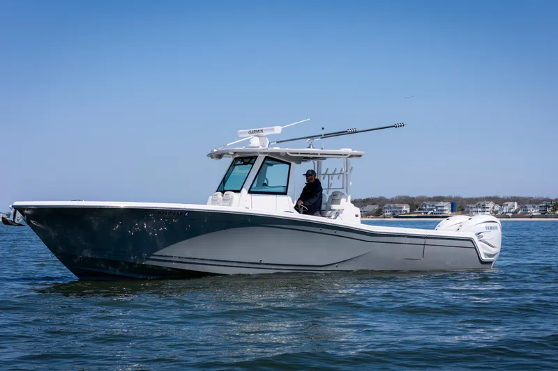 The Image of 2021 Caymas 341 CC boat cruising on calm water under clear blue sky. - 0