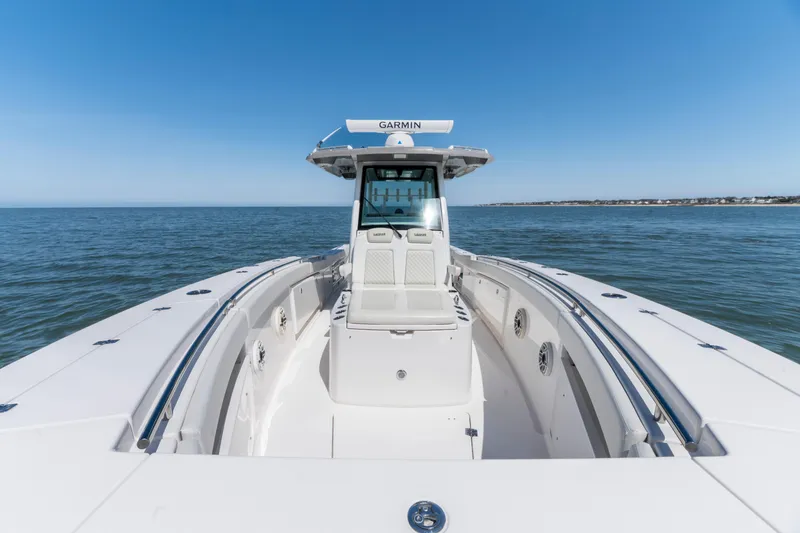Slide: The Image of 2021 Caymas 341 CC boat on open water under clear blue sky. - 12