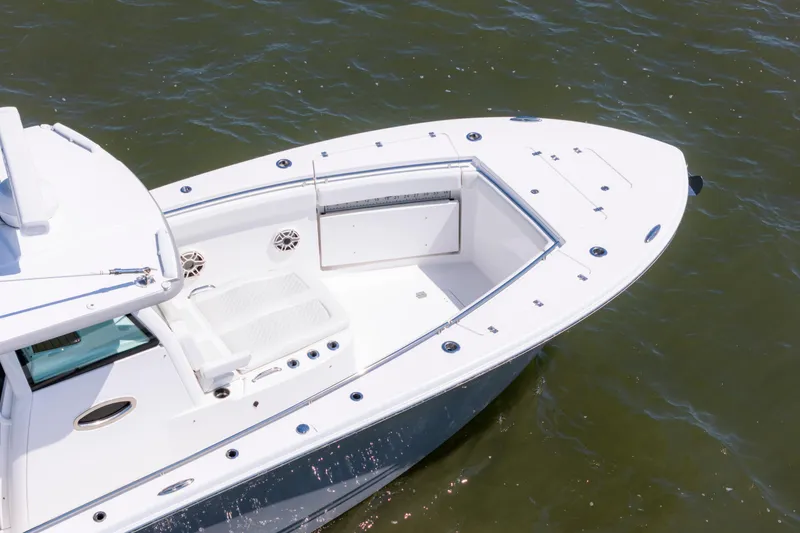 Slide: The Image of 2021 Caymas 341 CC boat on water, showcasing sleek design and spacious deck. - 13