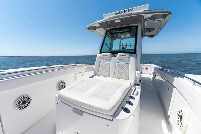 Slide: The Image of 2021 Caymas 341 CC boat interior with cushioned seating and ocean view. - 14