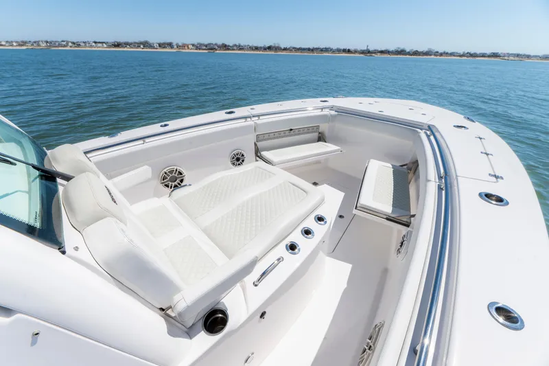 Slide: The Image of 2021 Caymas 341 CC boat interior with white seating, on calm water. - 16