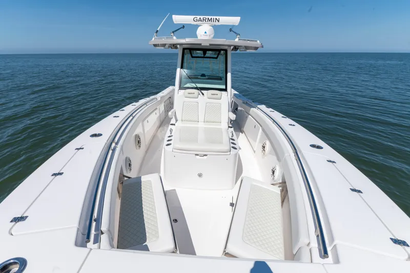 Slide: The Image of 2021 Caymas 341 CC boat on open water, featuring spacious seating and Garmin equipment. - 17