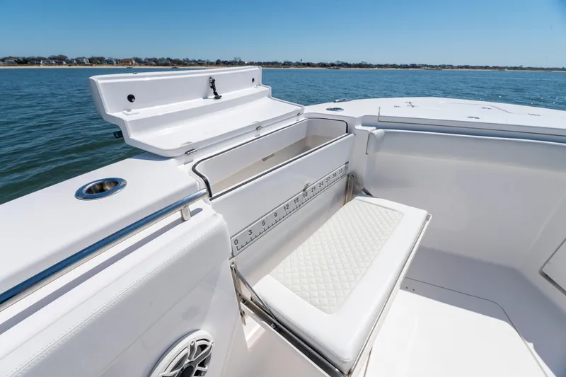 Slide: The Image of 2021 Caymas 341 CC boat interior with seating and storage, overlooking calm waters. - 19
