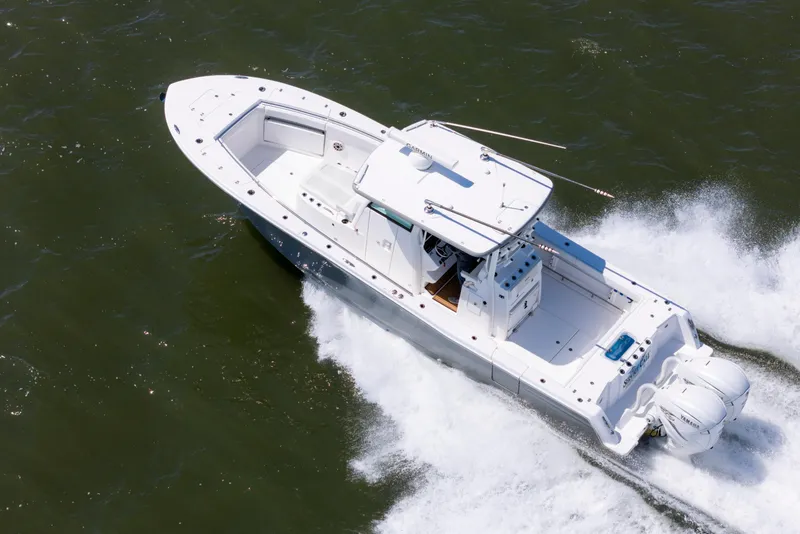 Slide: The Image of 2021 Caymas 341 CC boat cruising on open water, aerial view. - 4
