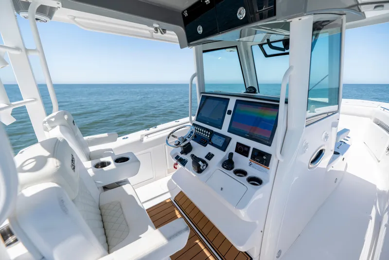 Slide: The Image of 2021 Caymas 341 CC boat cockpit with advanced navigation system and ocean view. - 5