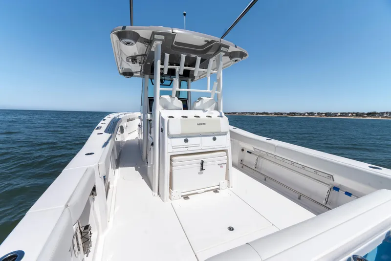 Slide: The Image of 2021 Caymas 341 CC boat on open water, showcasing spacious deck and sleek design. - 8