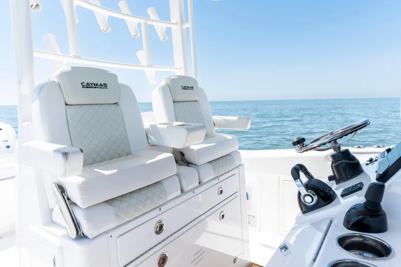 Slide: The Image of 2021 Caymas 341 CC boat interior with luxurious seating and steering console. - 9