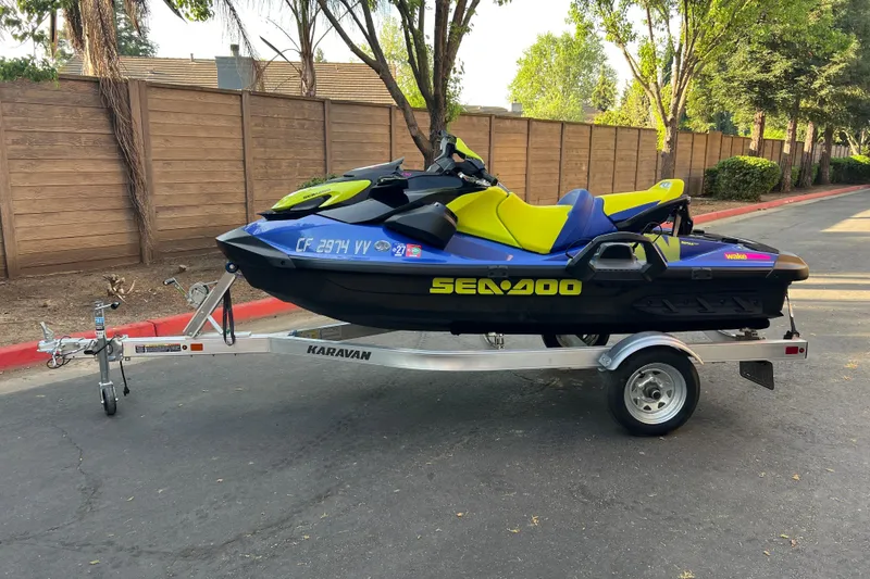 The Image of 2021 Sea-Doo Wake 170 jet ski on a Karavan trailer, parked outdoors. - 1