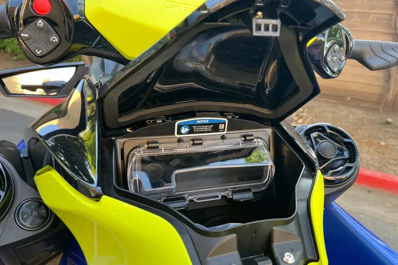 Slide: The Image of Open storage compartment of 2021 Sea-Doo Wake 170 watercraft, showcasing controls and interior features. - 10