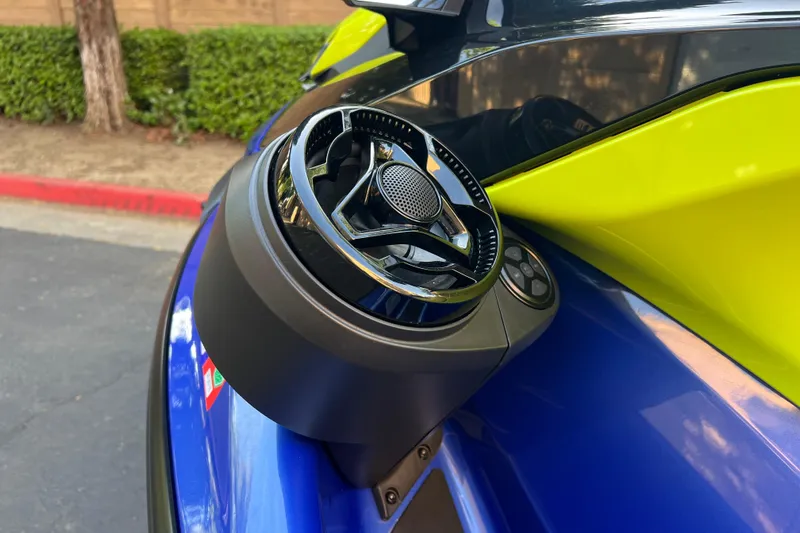 Slide: The Image of Close-up of 2021 Sea-Doo Wake 170 speaker system, featuring vibrant blue and yellow design. - 11