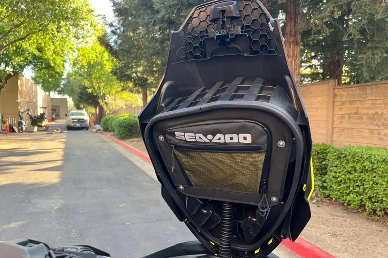 Slide: The Image of 2021 Sea-Doo Wake 170 jet ski with storage compartment open, parked outdoors. - 13