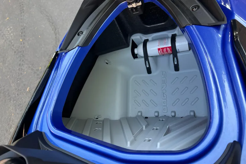 Slide: The Image of 2021 Sea-Doo Wake 170 storage compartment with fire extinguisher, blue exterior. - 14