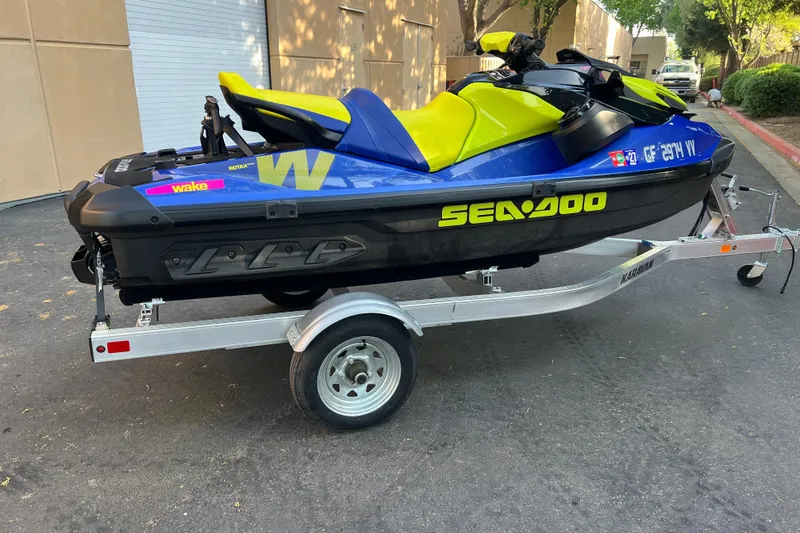 Slide: The Image of 2021 Sea-Doo Wake 170 jet ski on trailer, vibrant blue and yellow design. - 5