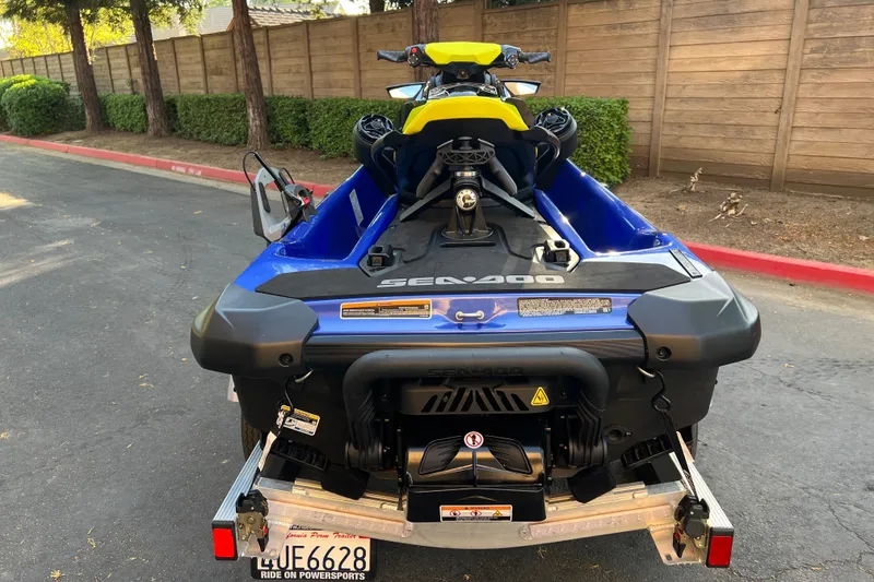Slide: The Image of 2021 Sea-Doo Wake 170 jet ski on trailer, parked on a street. - 6