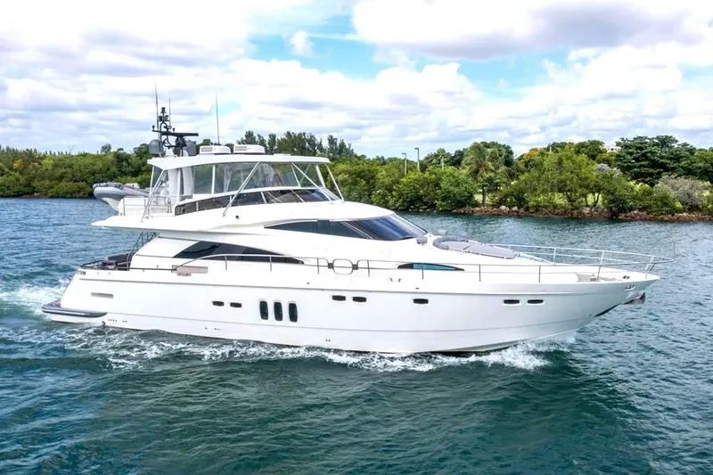The Image of Luxury Fairline 68 yacht cruising on water, 2020 model, with lush greenery in the background. - 0
