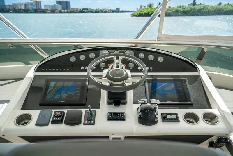Slide: The Image of Cockpit of 2020 Fairline 68 yacht with navigation screens and steering wheel. - 12