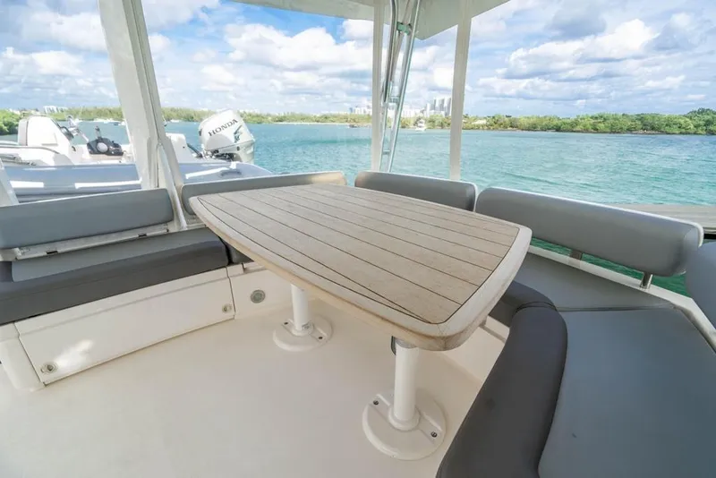 Slide: The Image of Luxury seating area on 2020 Fairline 68 yacht with scenic water view. - 14