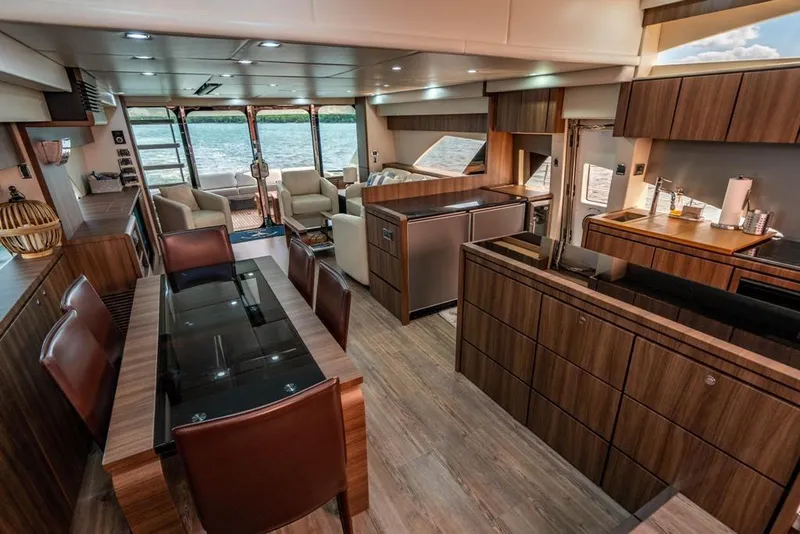 Slide: The Image of Luxurious interior of 2020 Fairline 68 yacht with modern wood finishes and spacious seating. - 33
