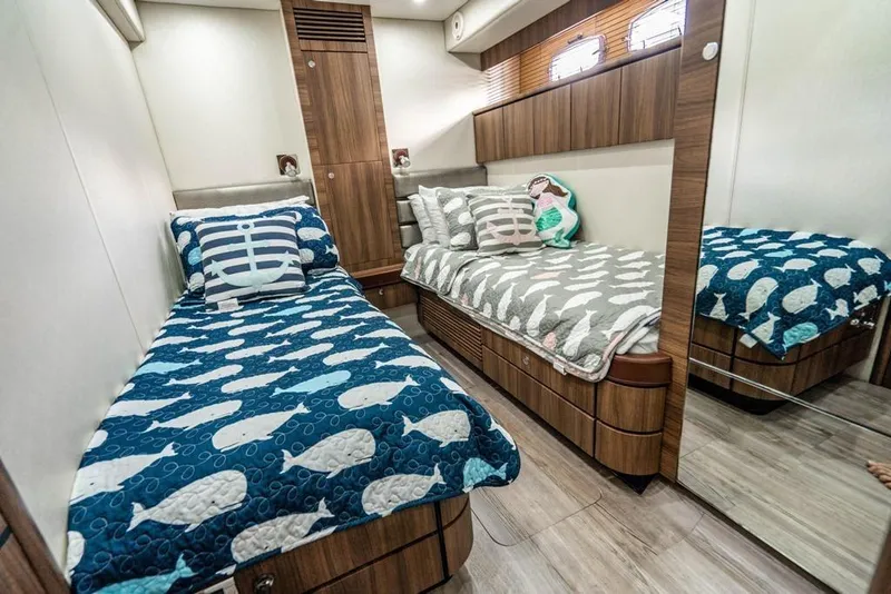 Slide: The Image of Luxurious twin cabin interior of 2020 Fairline 68 yacht with nautical-themed bedding. - 48