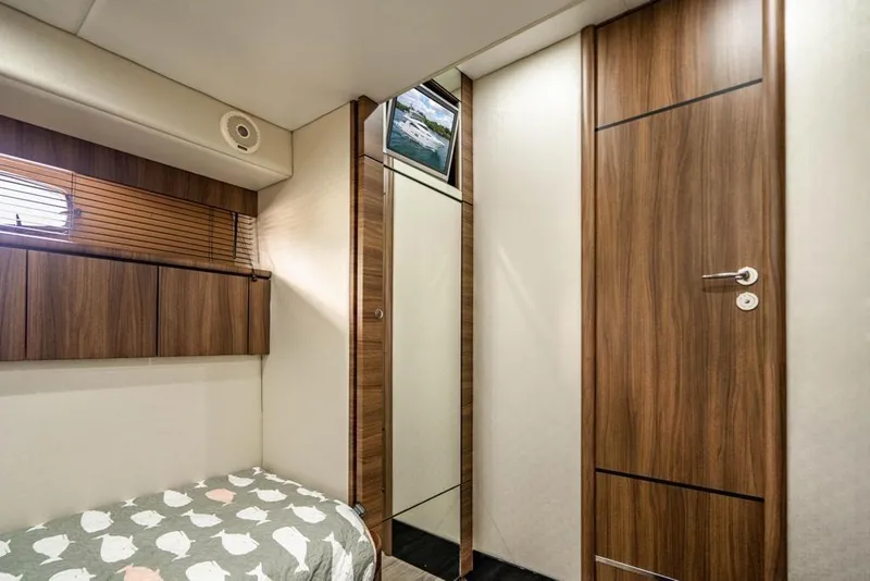 Slide: The Image of Interior cabin of 2020 Fairline 68 yacht with wood paneling and cozy bed. - 49