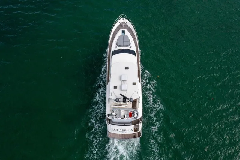 Slide: The Image of Aerial view of 2020 Fairline 68 yacht cruising on green ocean waters. - 5