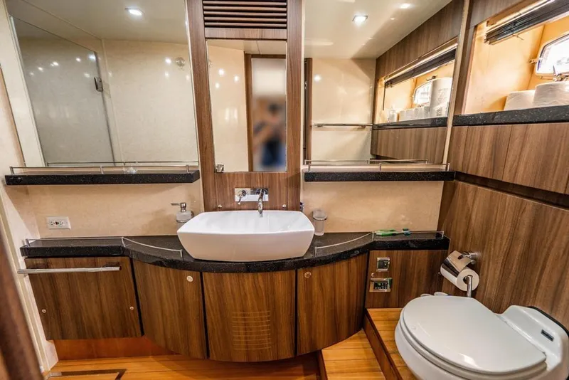 Slide: The Image of Luxurious bathroom interior on a 2020 Fairline 68 yacht, featuring modern wood finishes. - 57