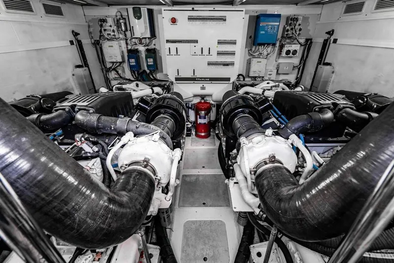 Slide: The Image of Engine room of a 2020 Fairline 68 yacht, featuring dual engines and control systems. - 60