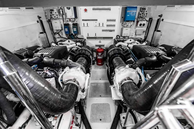 Slide: The Image of Engine room of a 2020 Fairline 68 yacht, showcasing dual engines and control systems. - 63