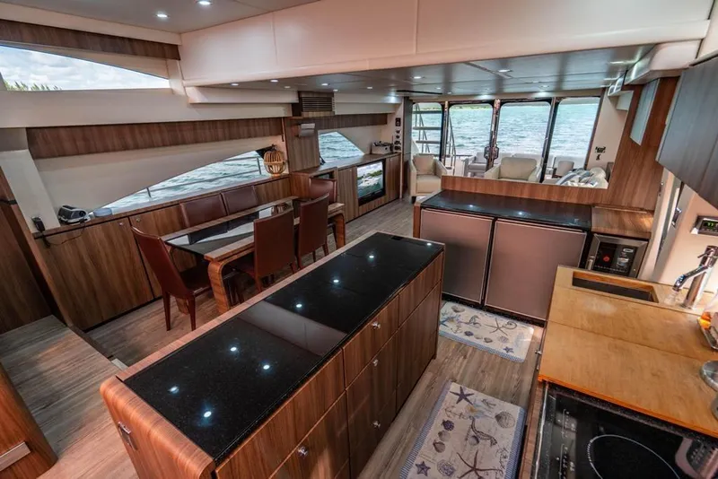 Slide: The Image of Luxurious interior of 2020 Fairline 68 yacht with modern kitchen and dining area. - 32