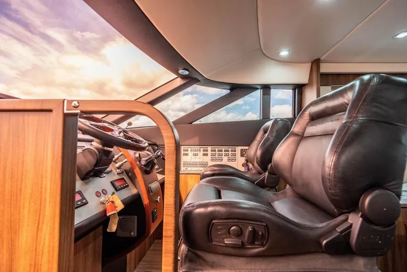 Slide: The Image of Luxurious interior of 2020 Fairline 68 yacht with leather seating and modern controls. - 36