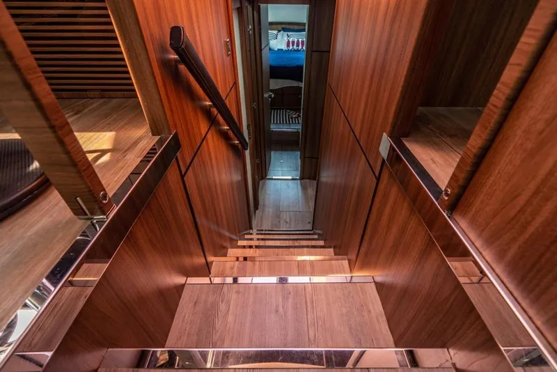 Slide: The Image of Luxurious wooden staircase interior of 2020 Fairline 68 yacht, leading to a cozy cabin. - 41