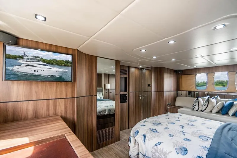 Slide: The Image of Luxurious interior of 2020 Fairline 68 yacht with elegant wood paneling and plush bedding. - 55