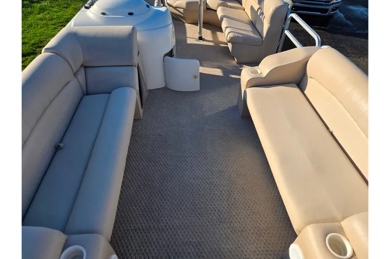 Slide: The Image of Interior of a 2005 Lowe Trinidad 220 pontoon boat with beige seating. - 10