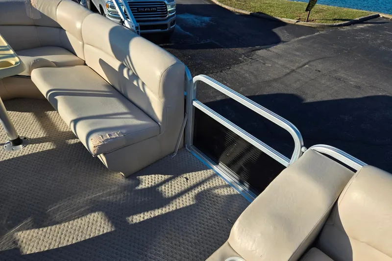 Slide: The Image of 2005 Lowe Trinidad 220 pontoon boat interior with beige seating and carpet. - 12