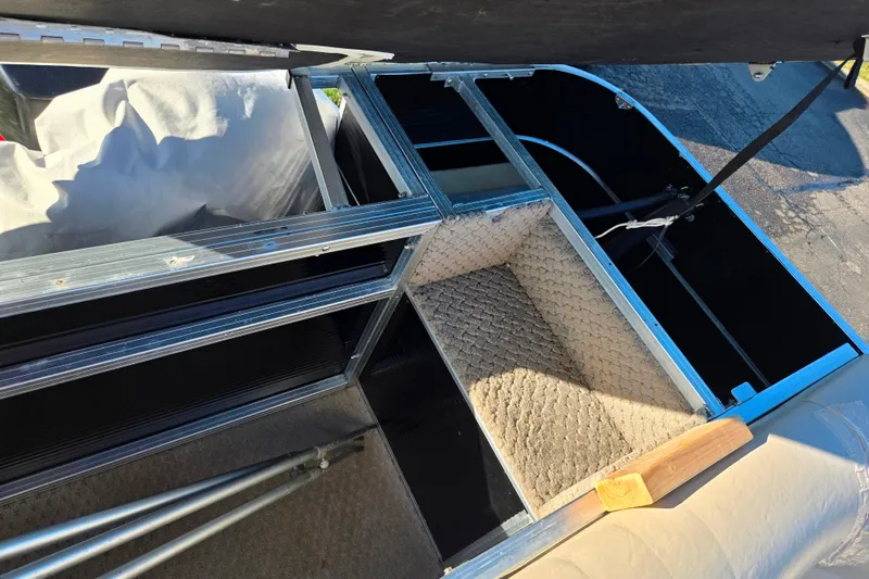 Slide: The Image of Interior view of a 2005 Lowe Trinidad 220 boat with storage compartments. - 16