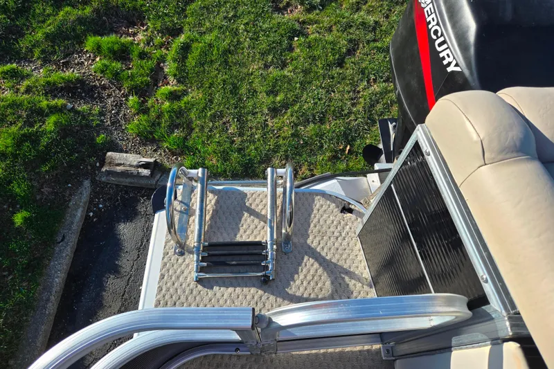 Slide: The Image of Rear view of a 2005 Lowe Trinidad 220 boat with ladder and Mercury engine. - 17