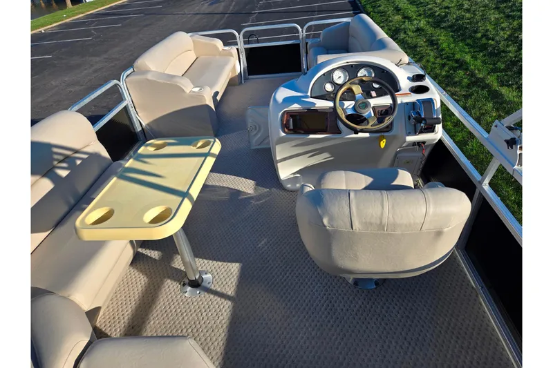 Slide: The Image of Interior of 2005 Lowe Trinidad 220 pontoon boat with beige seating and steering console. - 19
