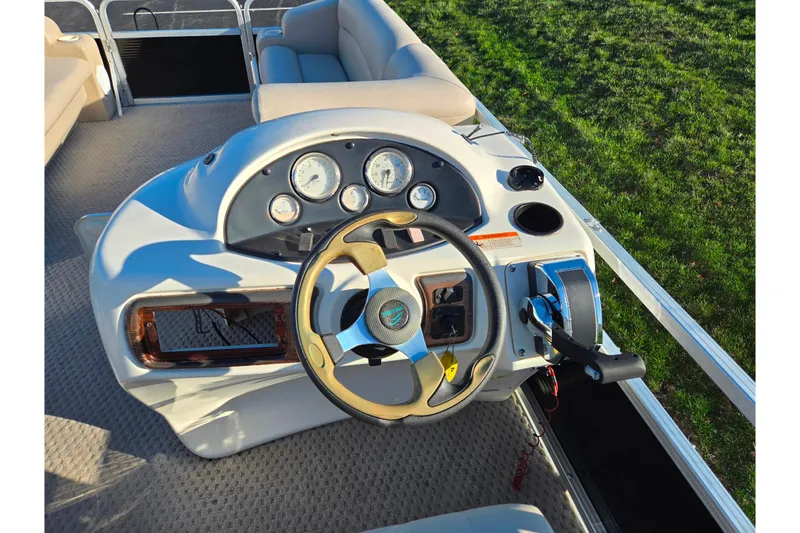 Slide: The Image of 2005 Lowe Trinidad 220 boat dashboard with steering wheel and control panel. - 20