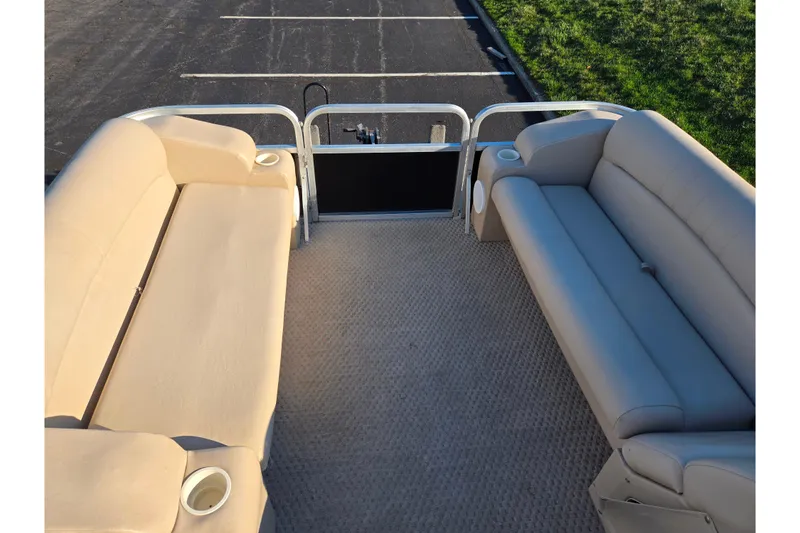 Slide: The Image of Interior view of a 2005 Lowe Trinidad 220 pontoon boat with beige seating. - 21
