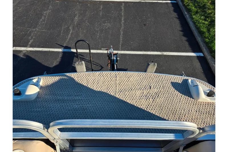 Slide: The Image of 2005 Lowe Trinidad 220 pontoon boat on trailer in parking lot. - 23