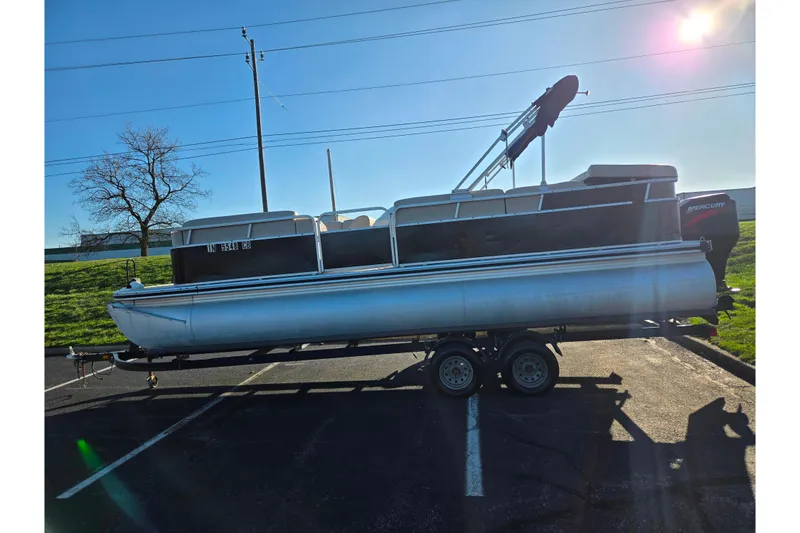 Slide: The Image of 2005 Lowe Trinidad 220 pontoon boat on trailer in sunny parking lot. - 4