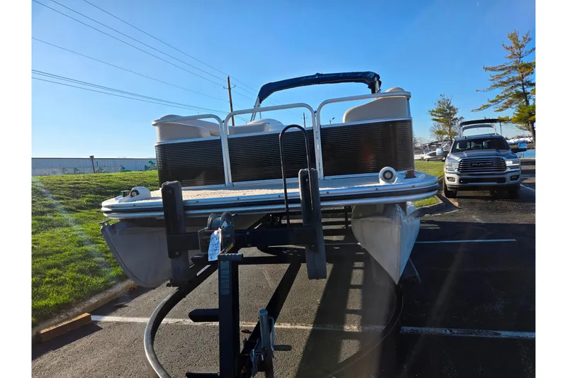 Slide: The Image of 2005 Lowe Trinidad 220 pontoon boat on trailer in parking lot, sunny day. - 6