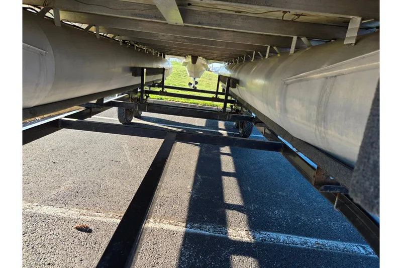 Slide: The Image of Underneath view of a 2005 Lowe Trinidad 220 pontoon boat on a trailer. - 7