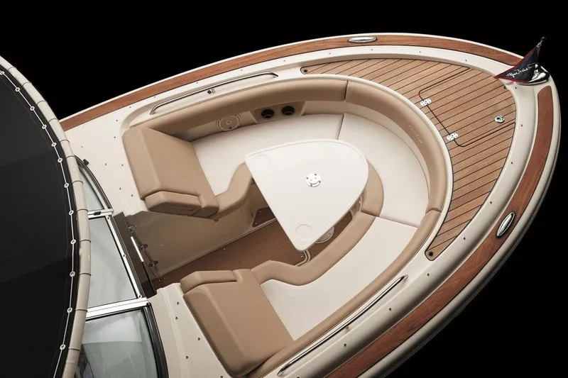 Slide: The Image of Manufacturer Provided Image: 2017 Chris-Craft Calypso 26 boat interior with tan seating and wooden deck. - 2