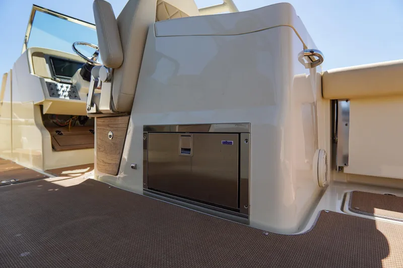 Slide: The Image of 2017 Chris-Craft Calypso 26 interior, featuring helm and seating area. - 22